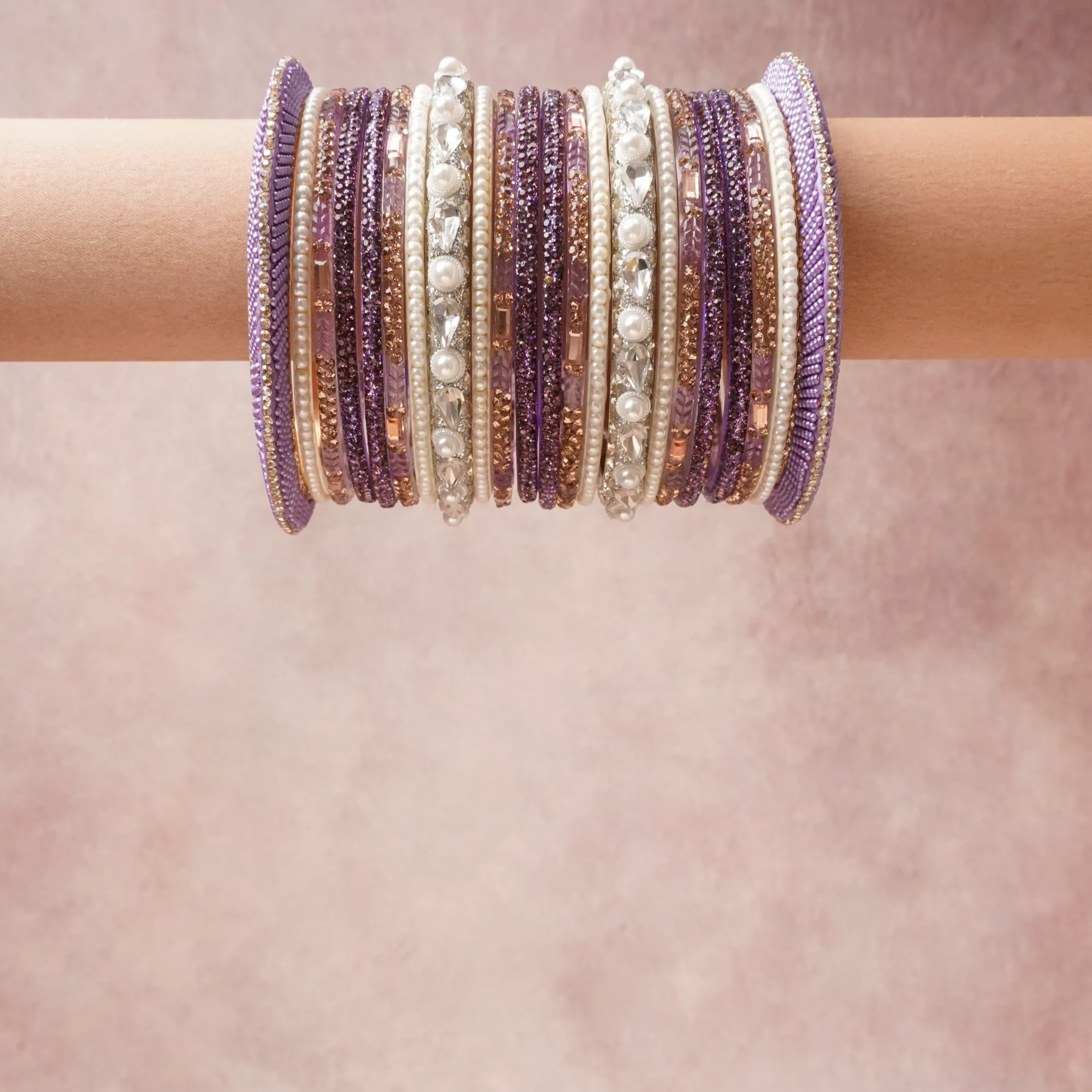 A grounding Amethyst Violet forms the heart of the set, while touches of Pearl Cream, Clear Crystal, Rose Gold, Lavender add charm.

A thoughtful composition of Glass, Rhinestones, Faux Pearls, Metallic Thread, Metal Alloy, designed to feel complete without being heavy.
Each element layers seamlessly, creating a look that is refined, wearable and quietly striking.